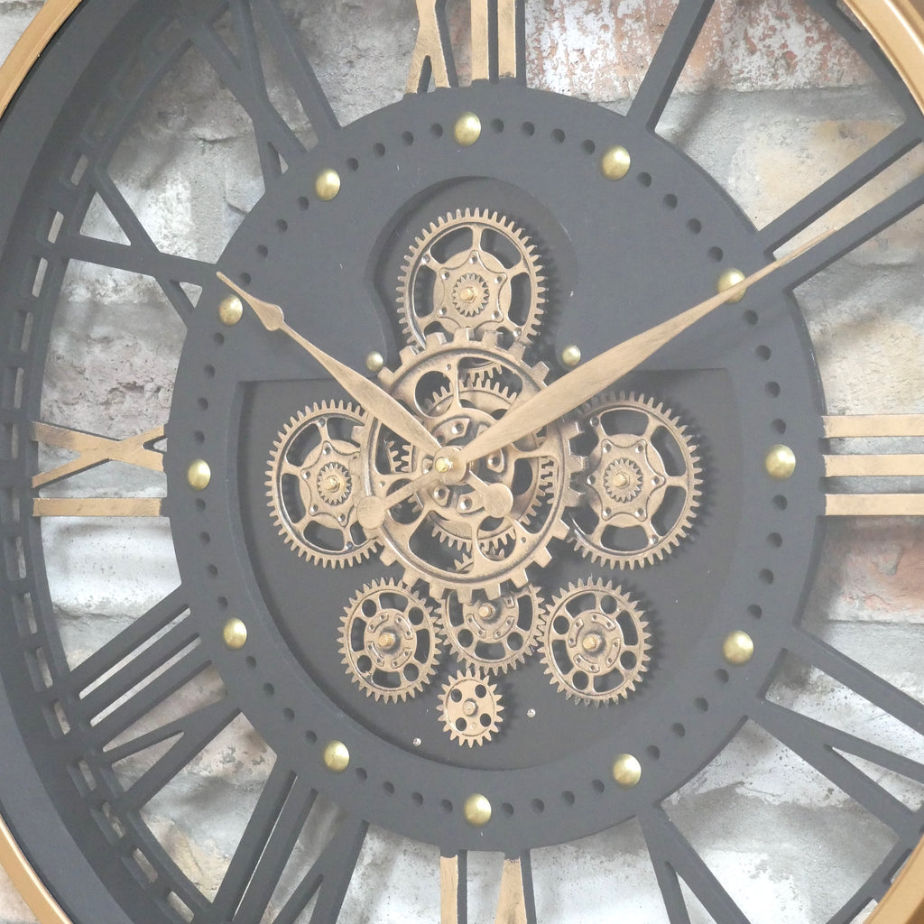 Gold frame skeleton working cog wall clock with black face