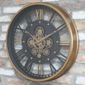Gold frame skeleton working cog wall clock with black face