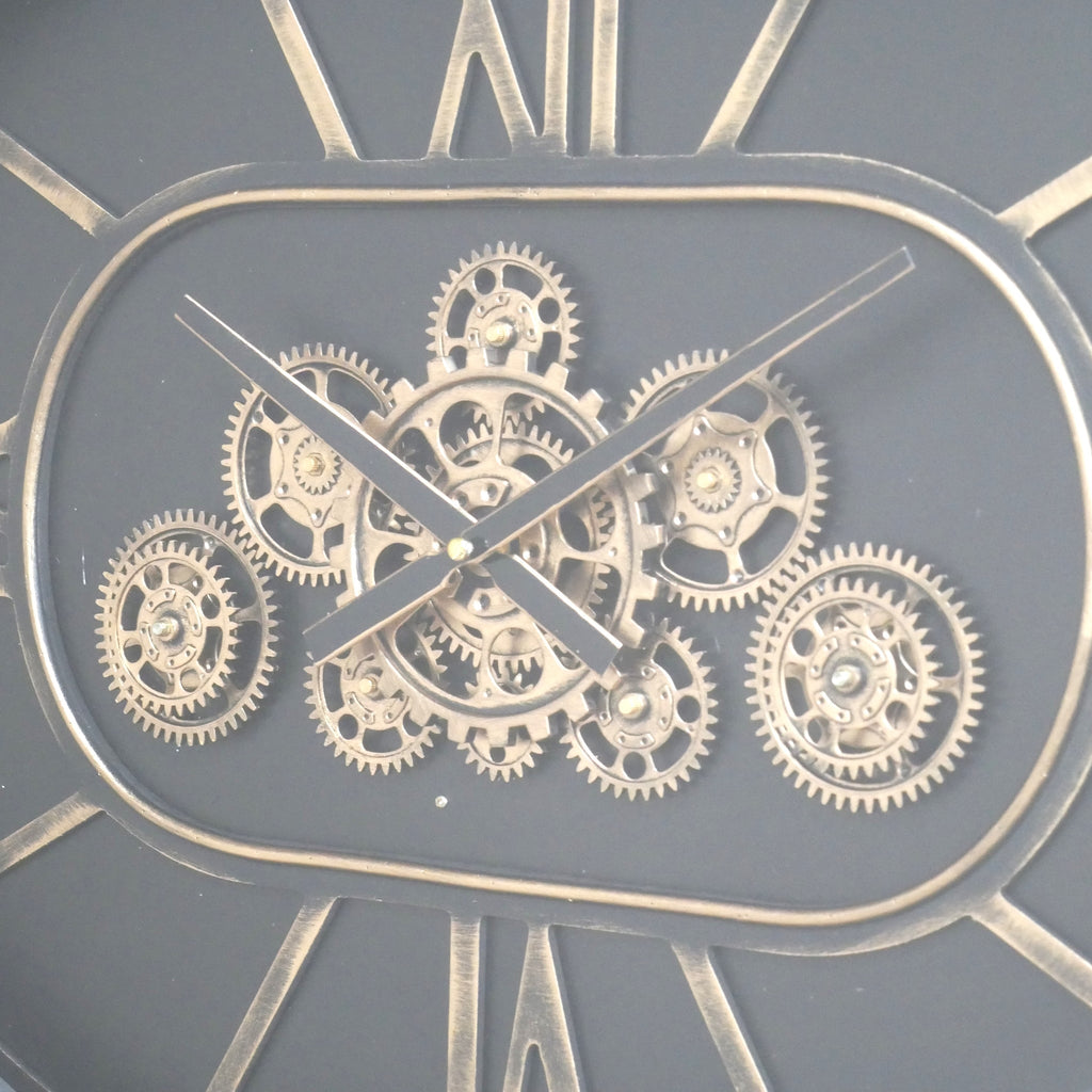 Oval working cog wall clock with black face