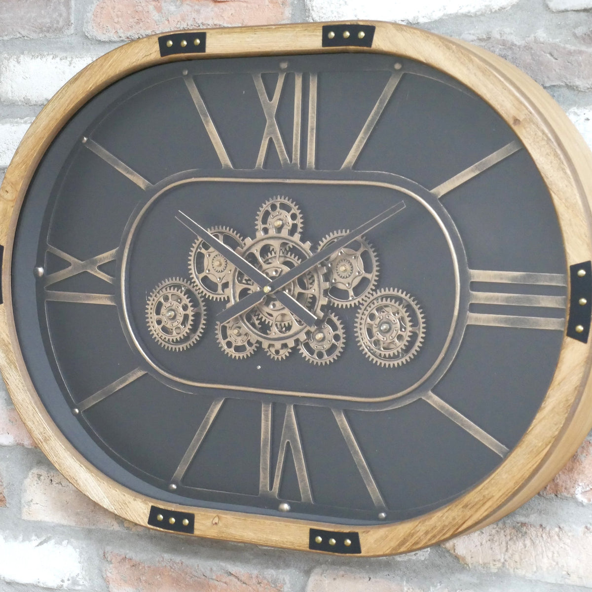 Oval working cog wall clock with black face
