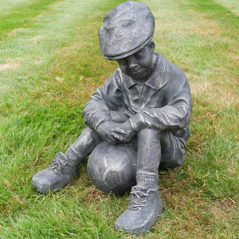 BOY SAT WITH FOOTBALL