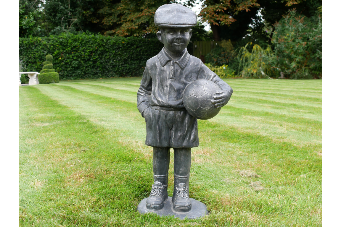 BOY STOOD WITH FOOTBALL