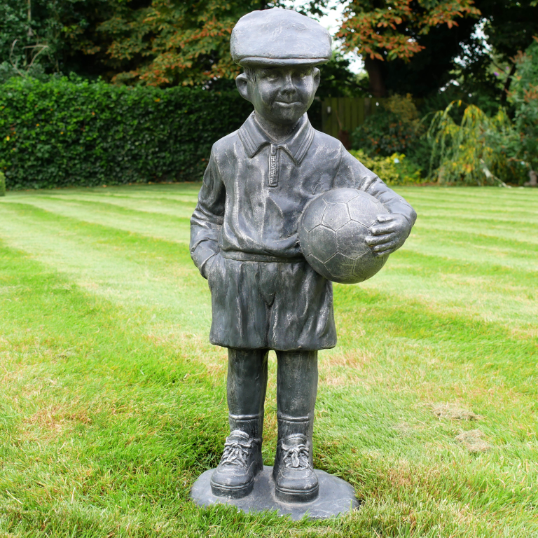 BOY STOOD WITH FOOTBALL