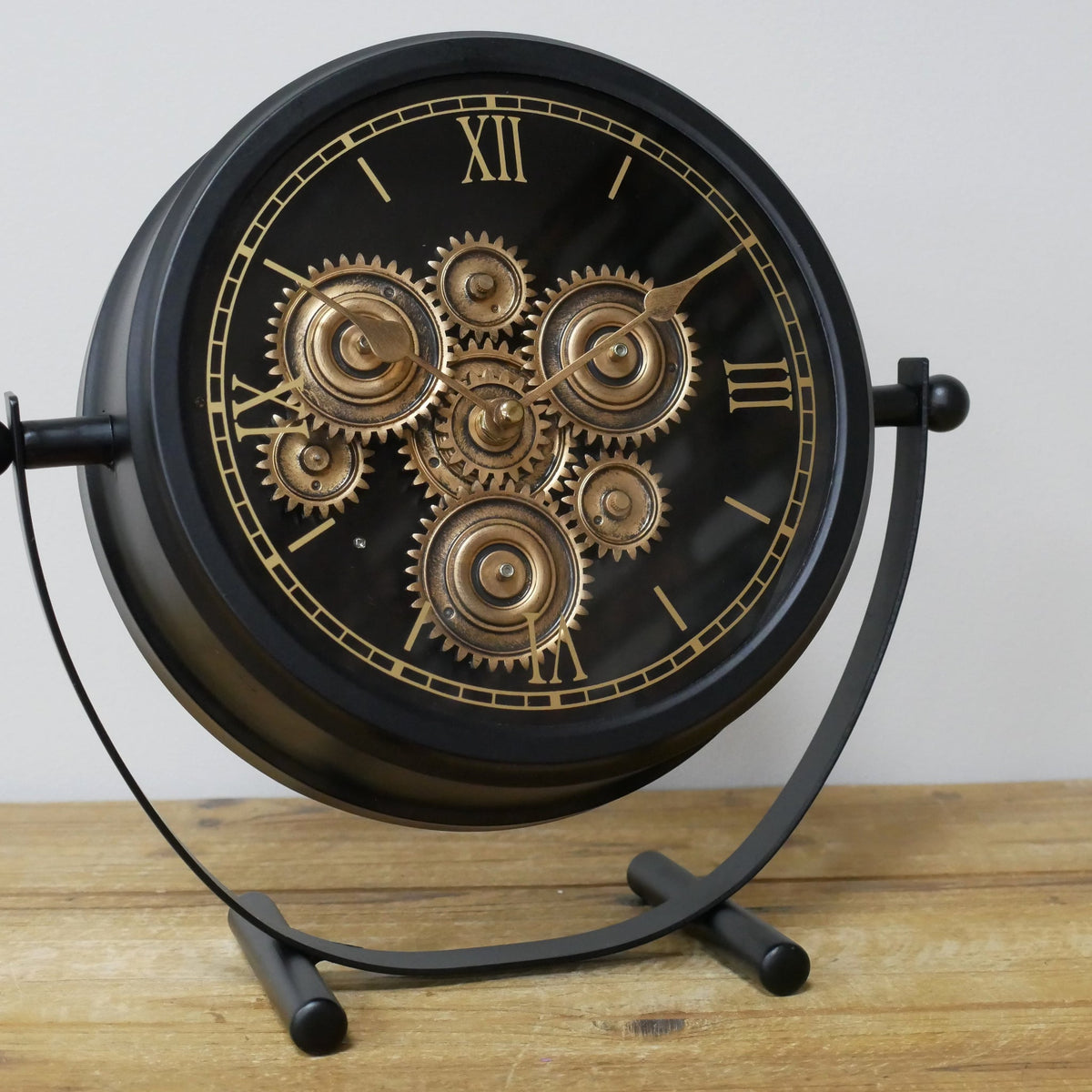 Small black working cog mantel clock on stand