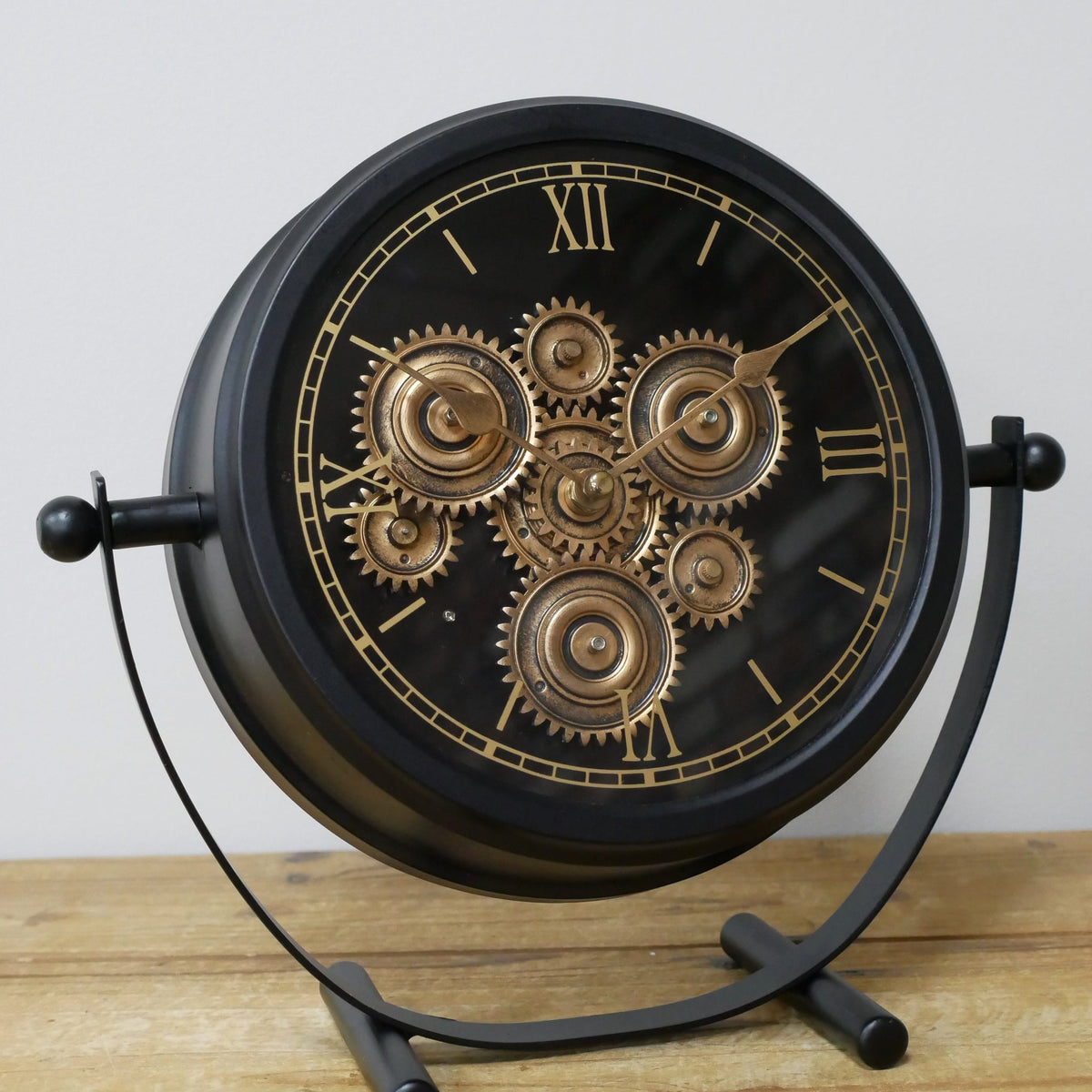 Small black working cog mantel clock on stand