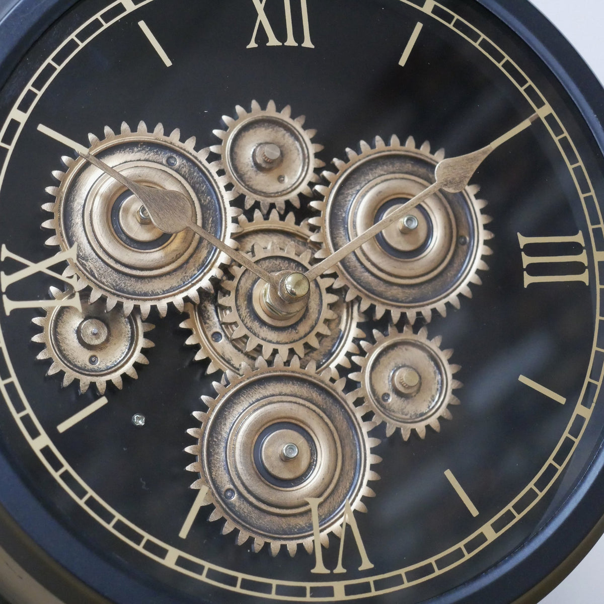 Small black working cog mantel clock on stand