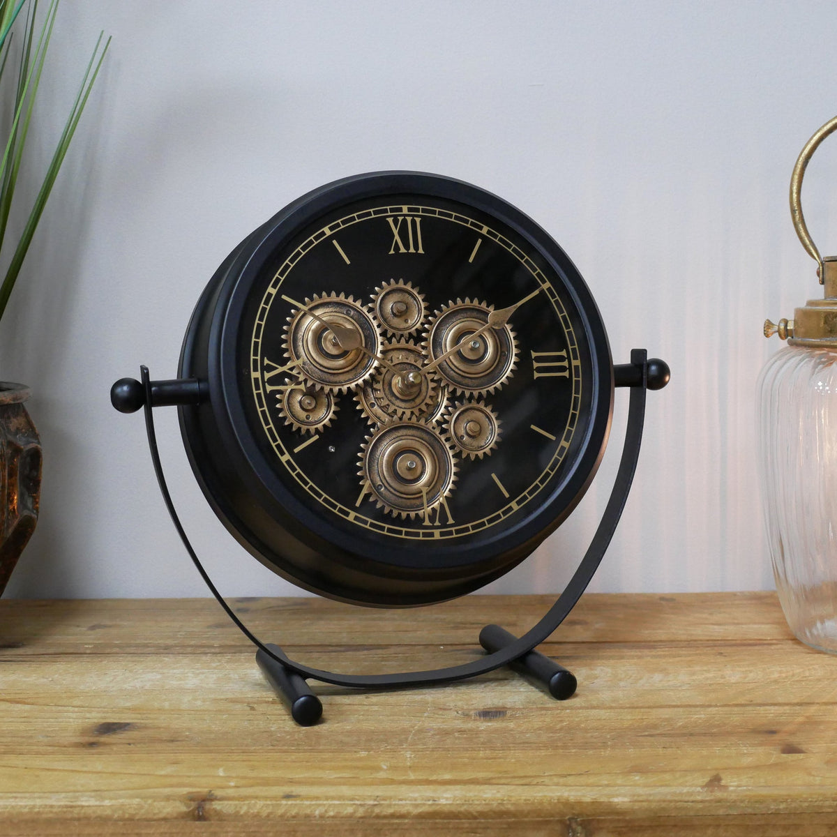 Small black working cog mantel clock on stand
